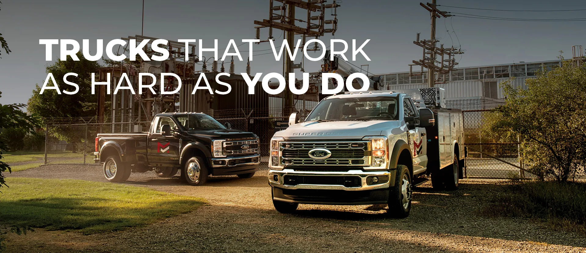 Background image featuring industrial equipment and utility trucks with bold text overlay: 'TRUCKS THAT WORK AS HARD AS YOU DO'